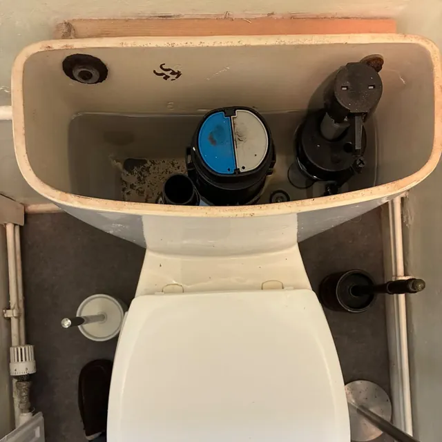 A toilet cistern with a new fill valve and flush valve